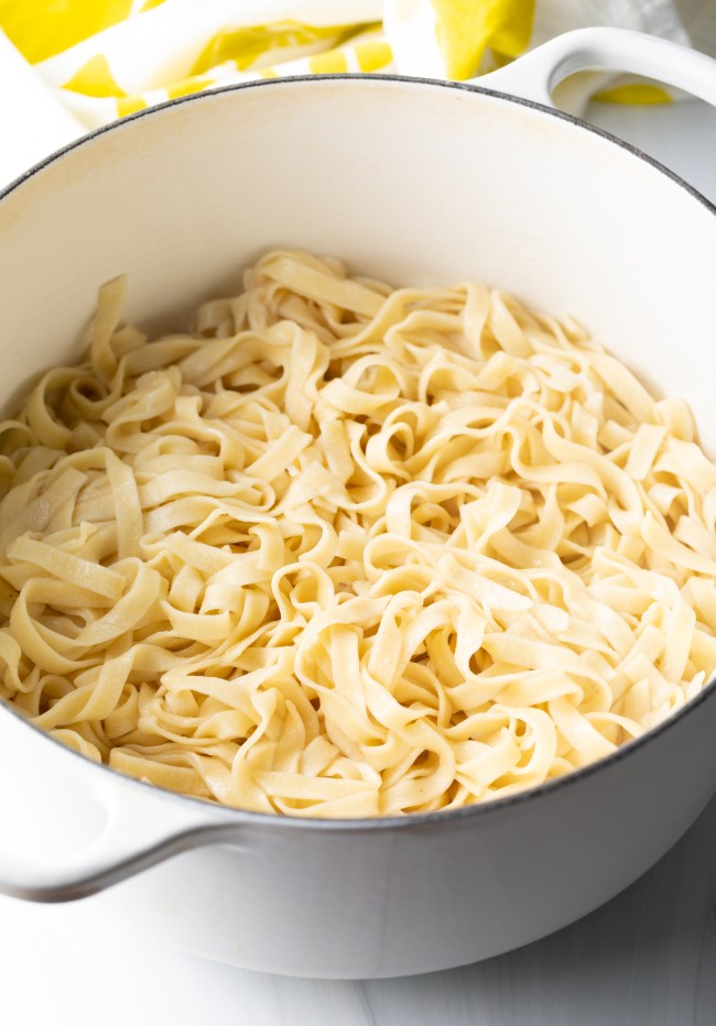 Large pot of cooked fettuccine noodles.