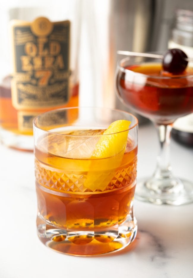 Perfect Manhattan Recipe in a rocks glass with a lemon rind. 