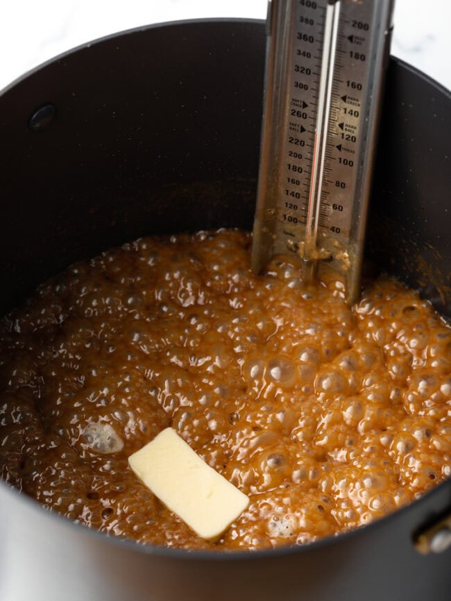 Butter added to the bubbling mixture in the sauce pot.