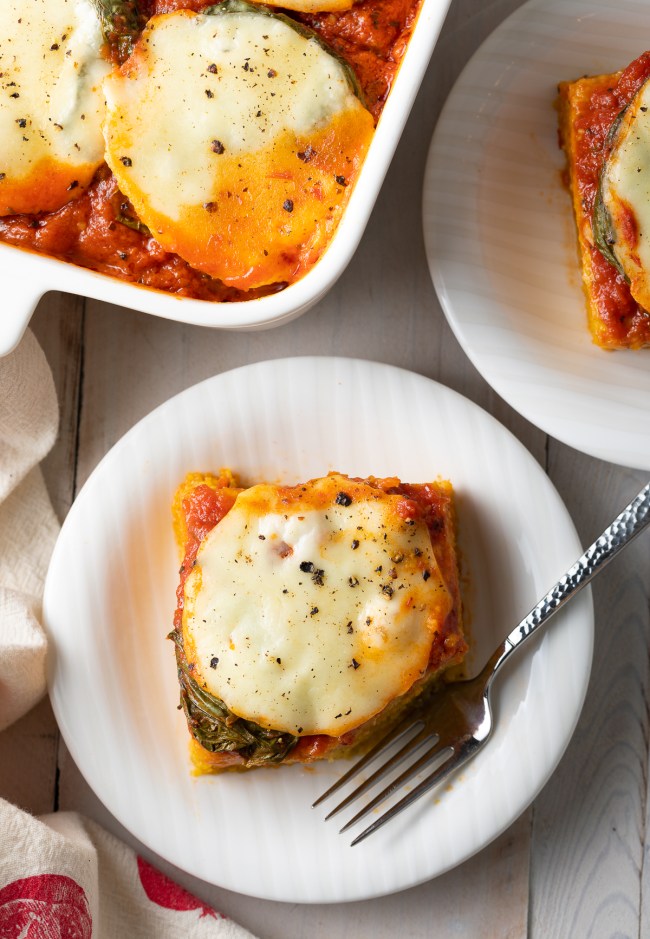 Italian Baked Polenta Recipe cut into squares on plates - overhead shot