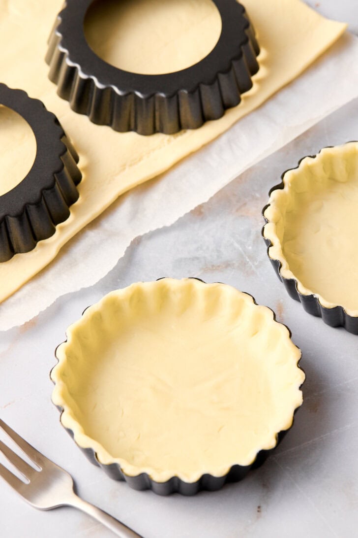 Pie crust lining mini tart pans. 