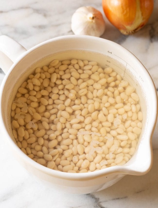 A pot full of the beans soaking before making this soup
