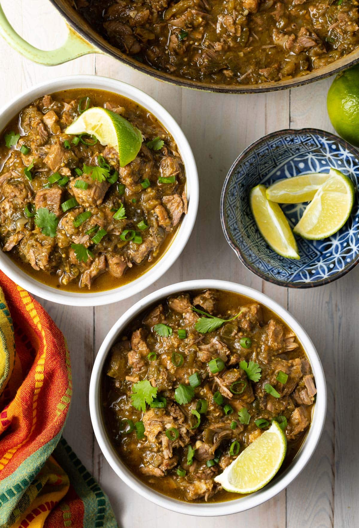 Bowls of new Mexican green chile with lime wedges on the side. 