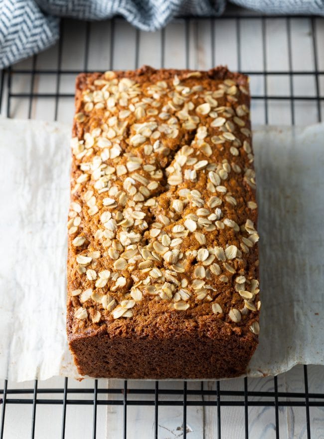 Loaf of banana bread on a cooling rack. 