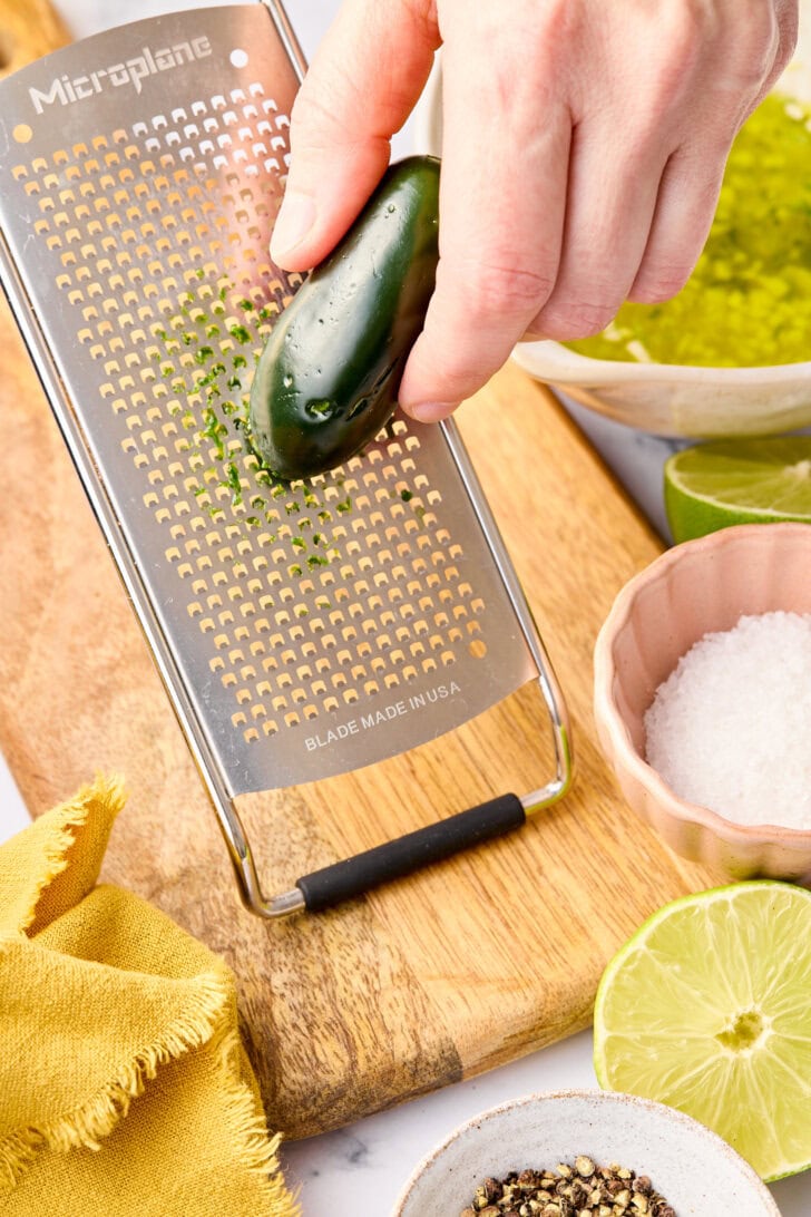 Grating jalapenos for oven salmon recipe.