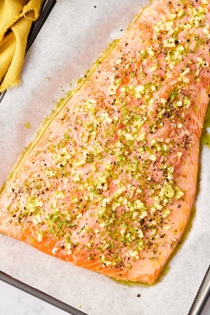 Raw salmon covered in marinade before being baked. 