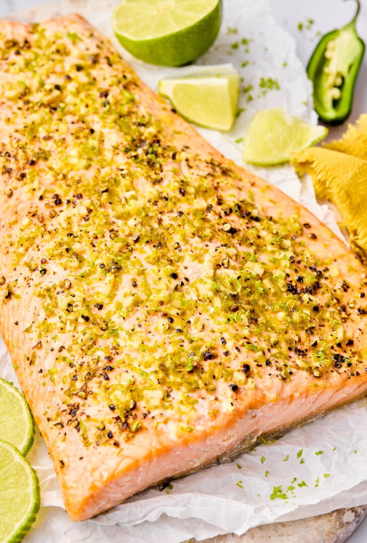 Oven Salmon Recipe with lime and jalapenos on plate.