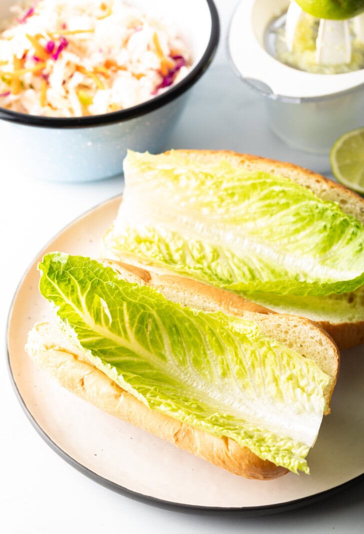 Large romaine lettuce leaf on a hoagie roll.