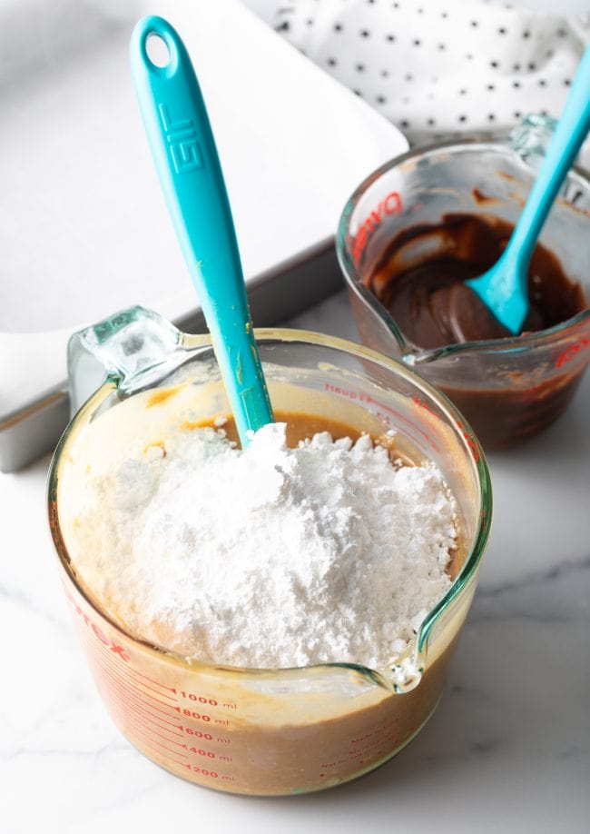 adding powdered sugar to the peanut butter mixture