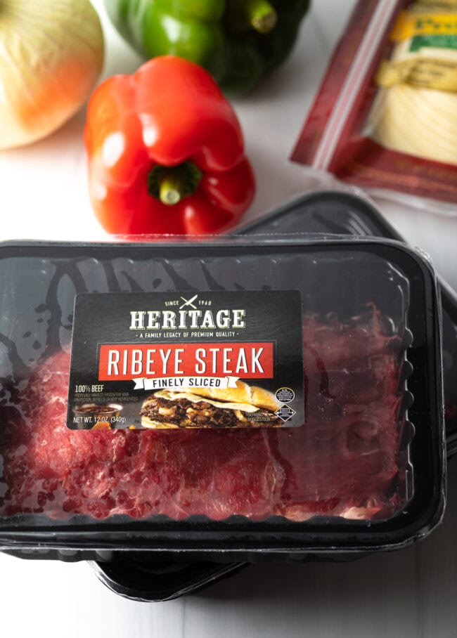 Package of unopened sliced ribeye steak.