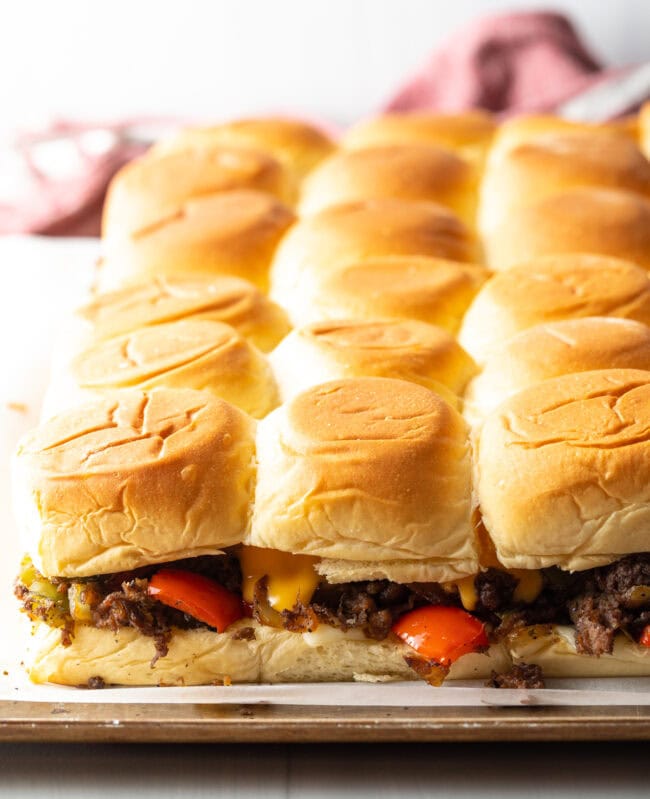 Baked steak sliders on a pan.