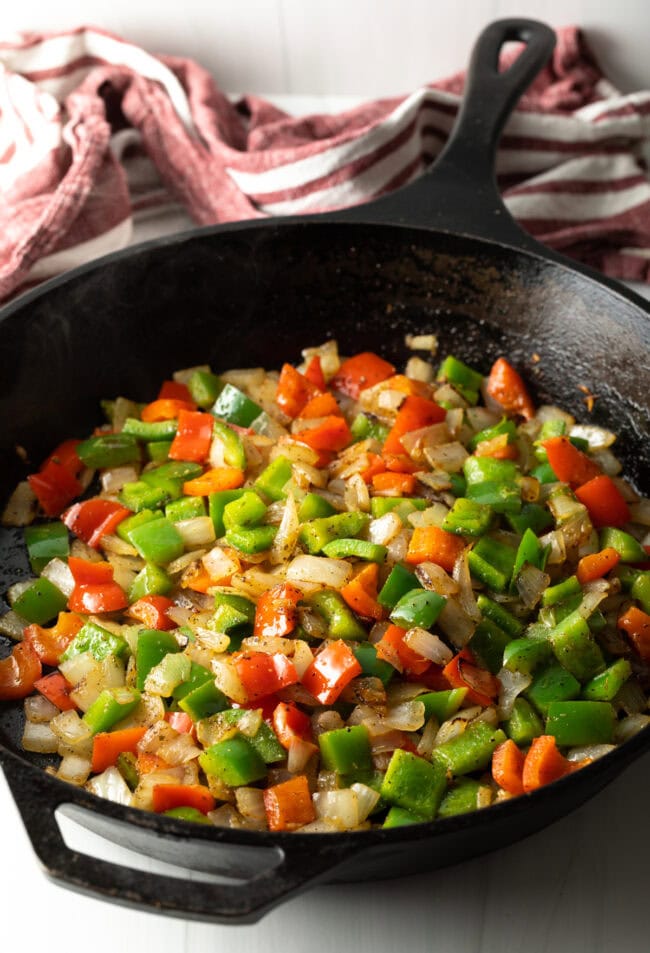 Skillet with sauteed peppers and onions.