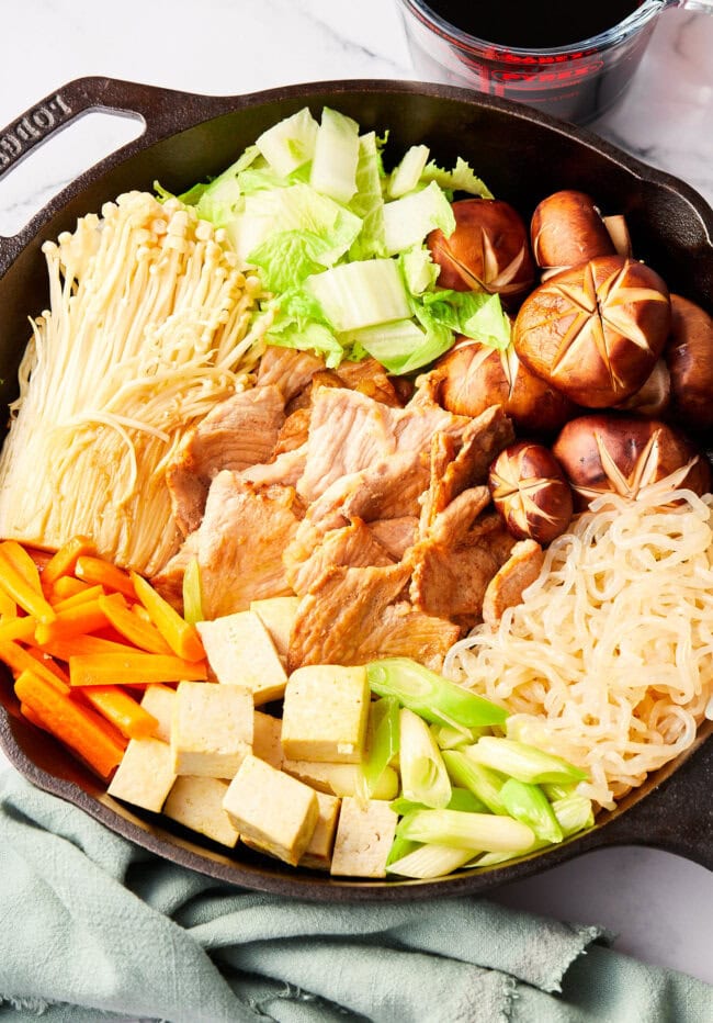 pork sukiyaki ingredients in skillet