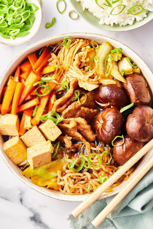 Pork Sukiyaki in a bowl with chopsticks 