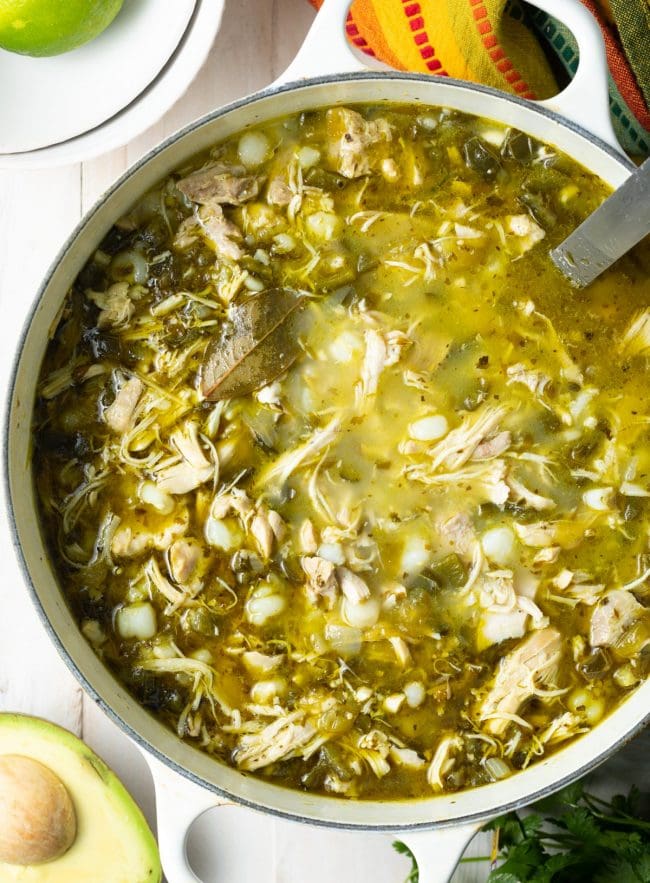 Overhead shot of green pozole in a pot. 