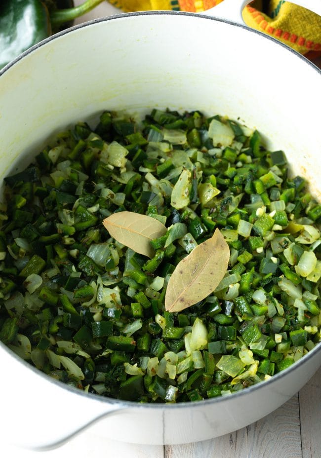 cooking peppers in a large pot with bay leaves and spices. 