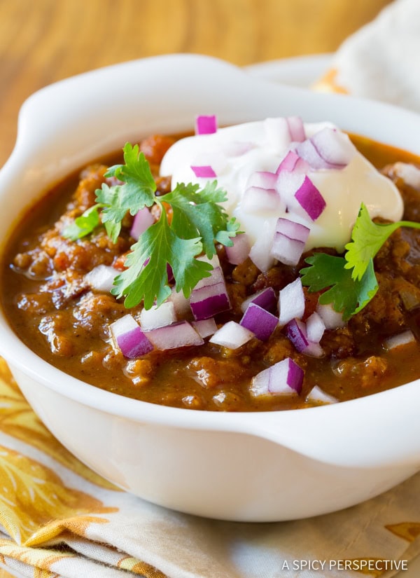 Chili with all of the toppings like cilantro, sour cream and onions. 