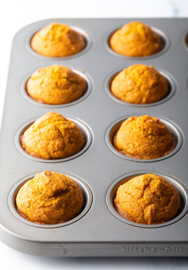 1 dozen baked muffins cooling in a pan.