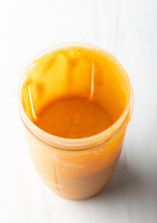 Blender jar with pumpkin smoothie.