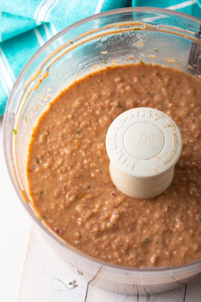 Pinto beans and pico de gallo in the food processor after being blended. 