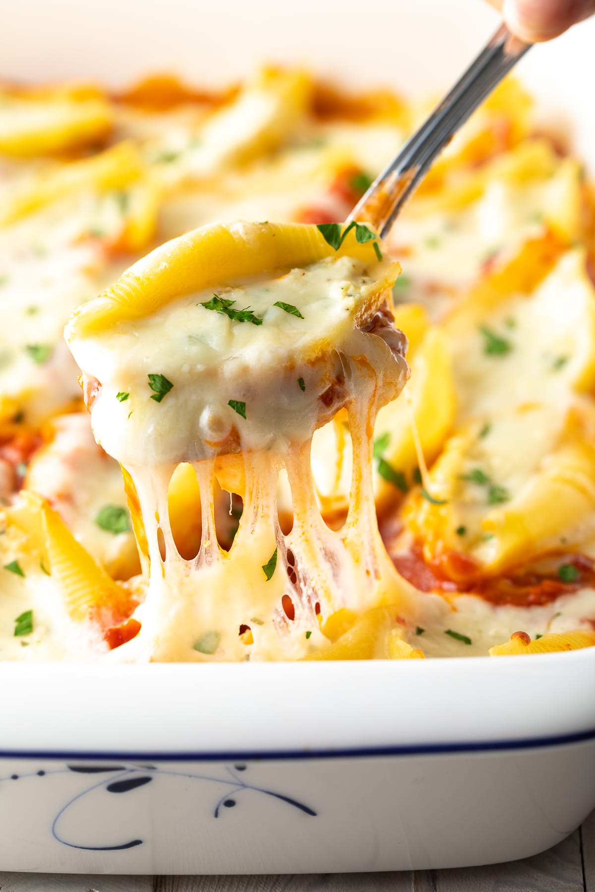 Best Classic Ricotta Stuffed Shells Recipe lifted out of pan