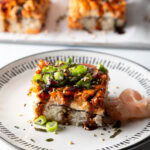 Square of sushi bake on a white plate.