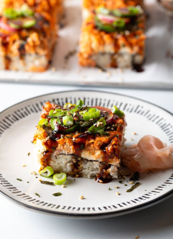 Square of sushi bake on a white plate.