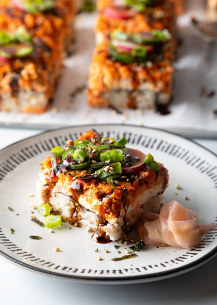 Square of sushi bake on a white plate.