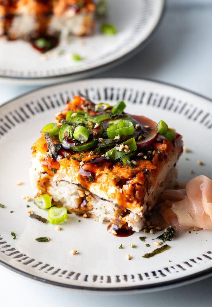 Square of sushi bake on a white plate.