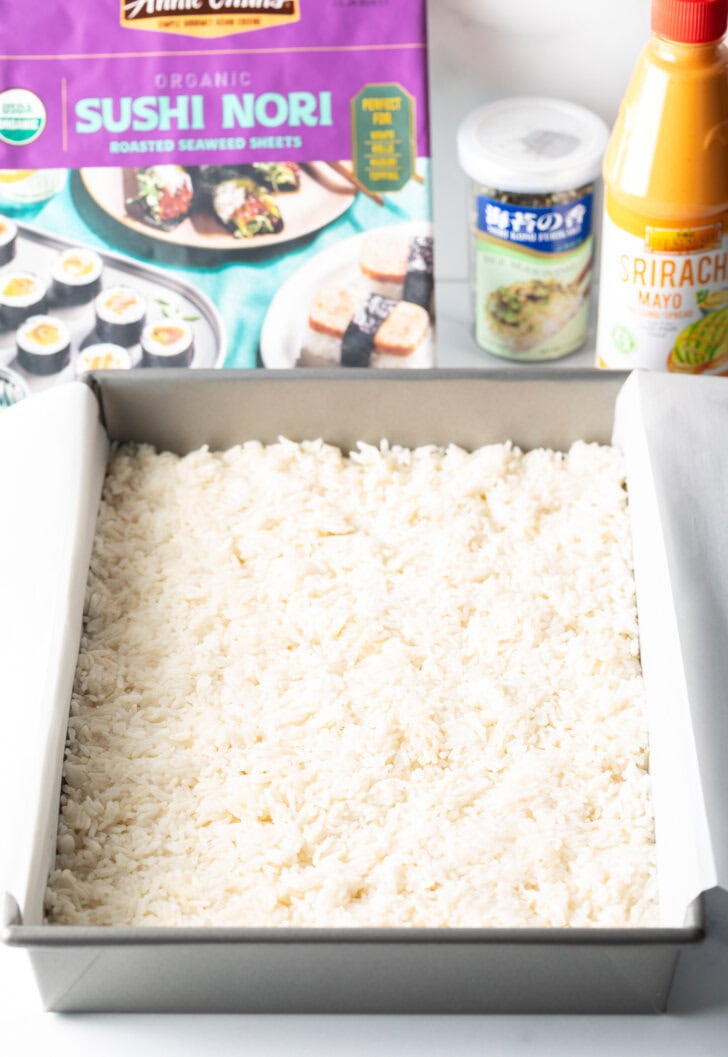 White rice pressed into a rectangle baking pan.