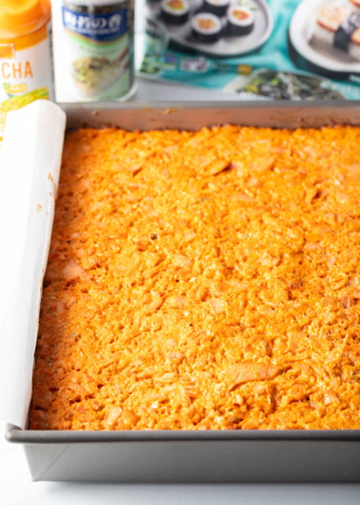 Cooked salmon mixture pressed into a rectangle baking pan.