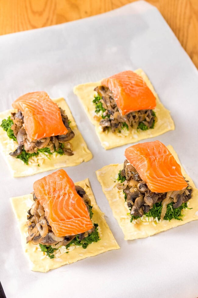 Assembling the salmon Wellington on a baking sheet lined with parchment paper. 