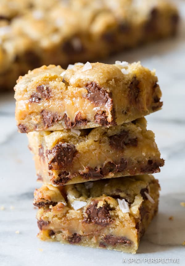 Amazing Salted Caramel Chocolate Chip Cookie Bars, with gooey caramel centers. This cookie bar recipe is so delicious, everyone will ask for the recipe. #ASpicyPerspective #cookiebars #cookies #chocolatechip #baking #dessert