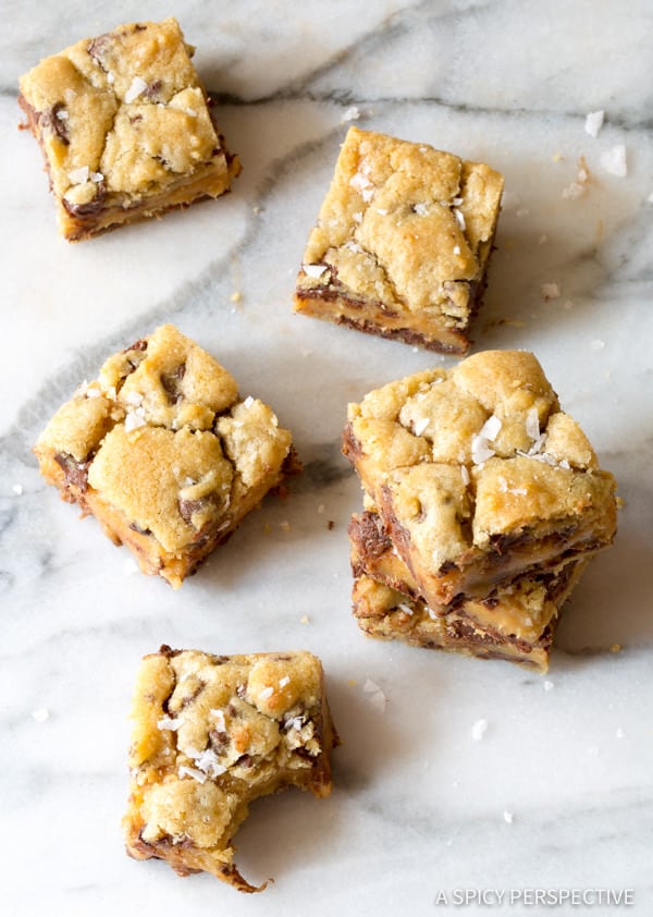 Amazing Salted Caramel Cookies Bars, with gooey caramel centers. This cookie bar recipe is so delicious, everyone will ask for the recipe. #ASpicyPerspective #cookiebars #cookies #chocolatechip #baking #dessert