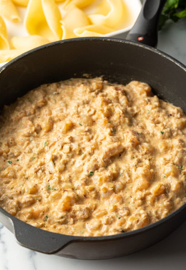 Seafood meat and cheese mixture in a saucepan.