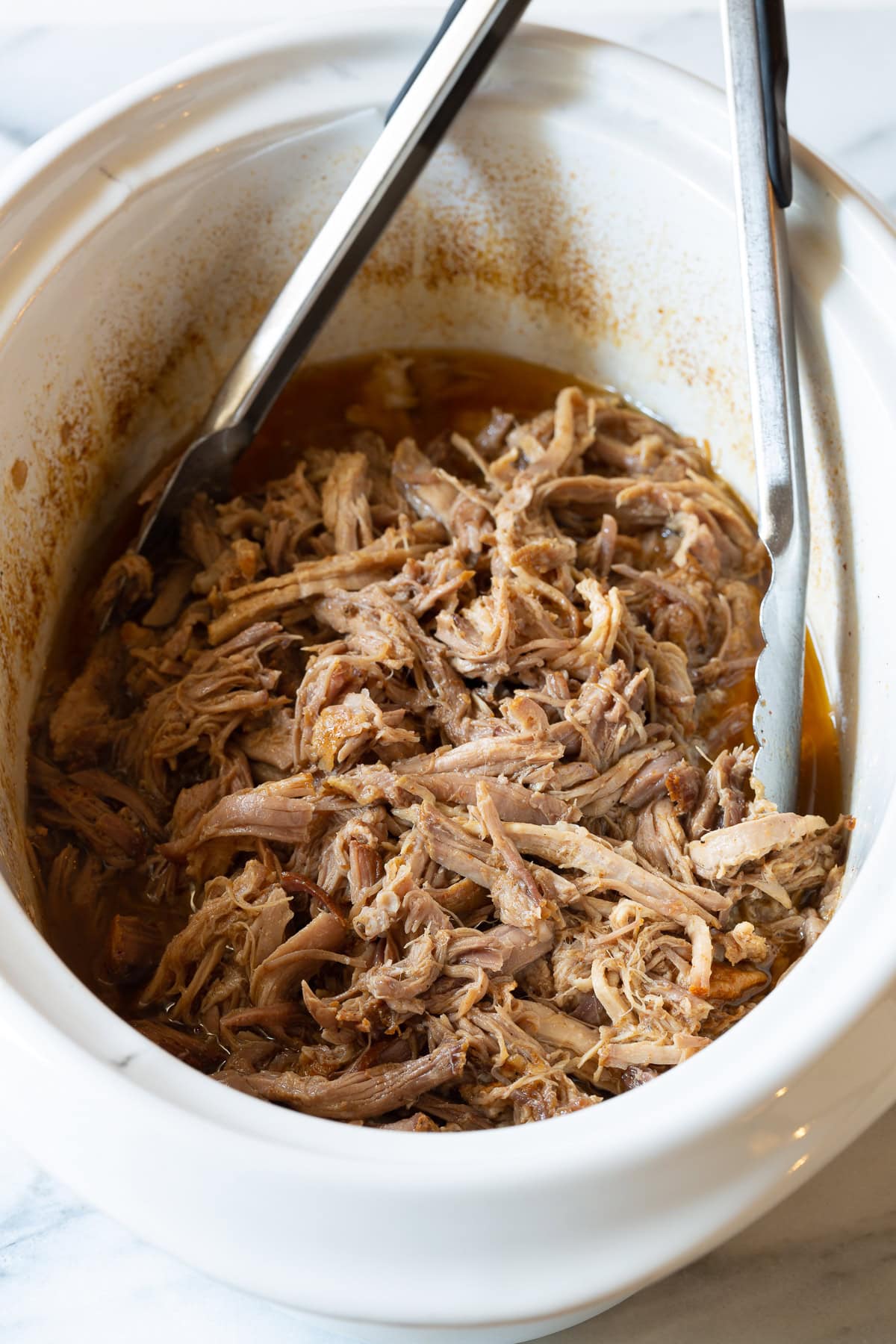 shredded smoked pulled pork in a crockpot ready to serve 