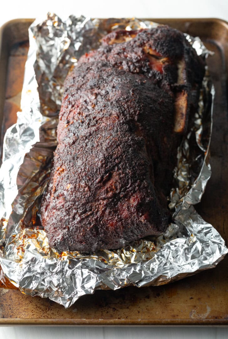 Smoked meat unwrapped from aluminum foil.