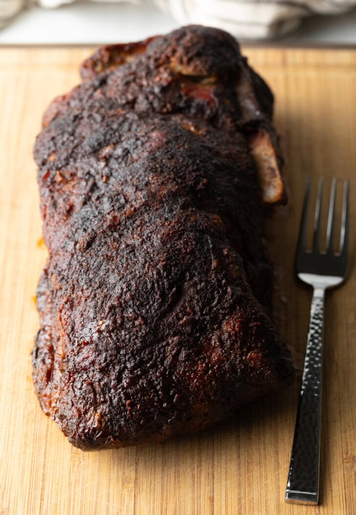 Smoked pork butt on a wood cutting board.