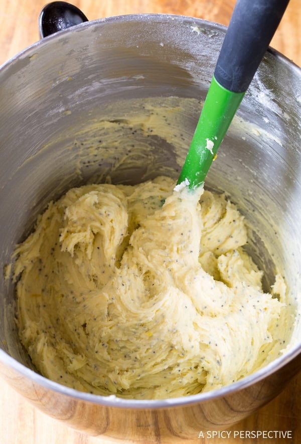 lemon cookie dough in a stand mixer bowl with a rubber spatula. 