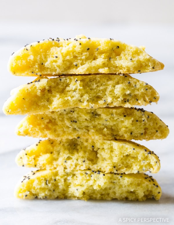 Lemon poppy seed cookies broken in half and stacked on top of each other. 