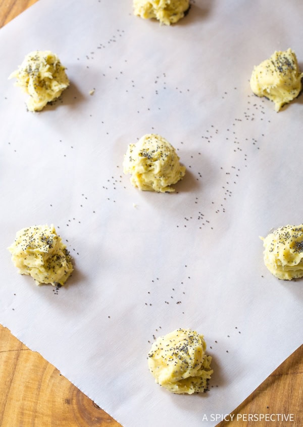 Cookie dough balls on a baking sheet lined with parchment paper. 