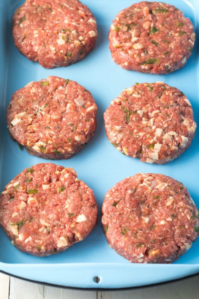 Raw Burger Patties on a serving plate. 