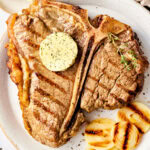 Porterhouse Steak with Compound Herb Butter - overhead shot on plate