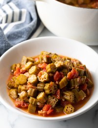 White bowl filled with stewed okra and tomatoes.