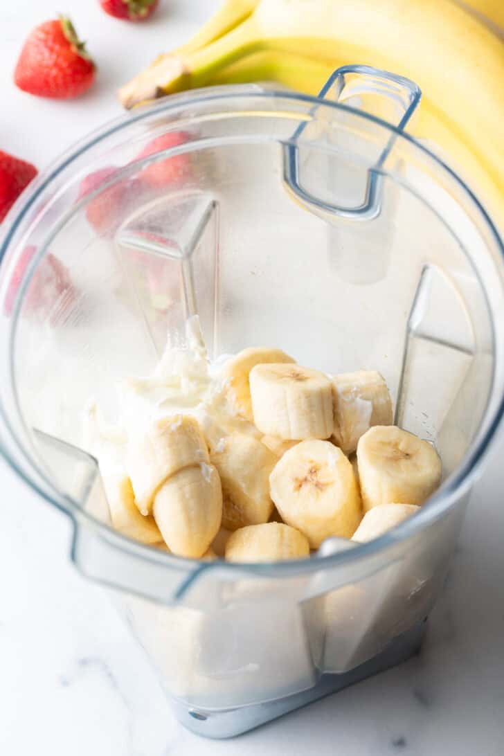 Frozen chunks of banana in a blender jar.