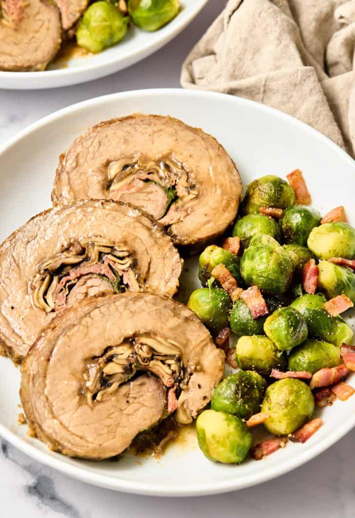 Stuffed Flank Steak Recipe with Prosciutto and Mushrooms on plate