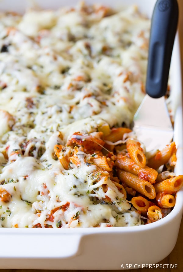 Supreme Pizza Baked Ziti Recipe  in a baking dish with a spatula. 