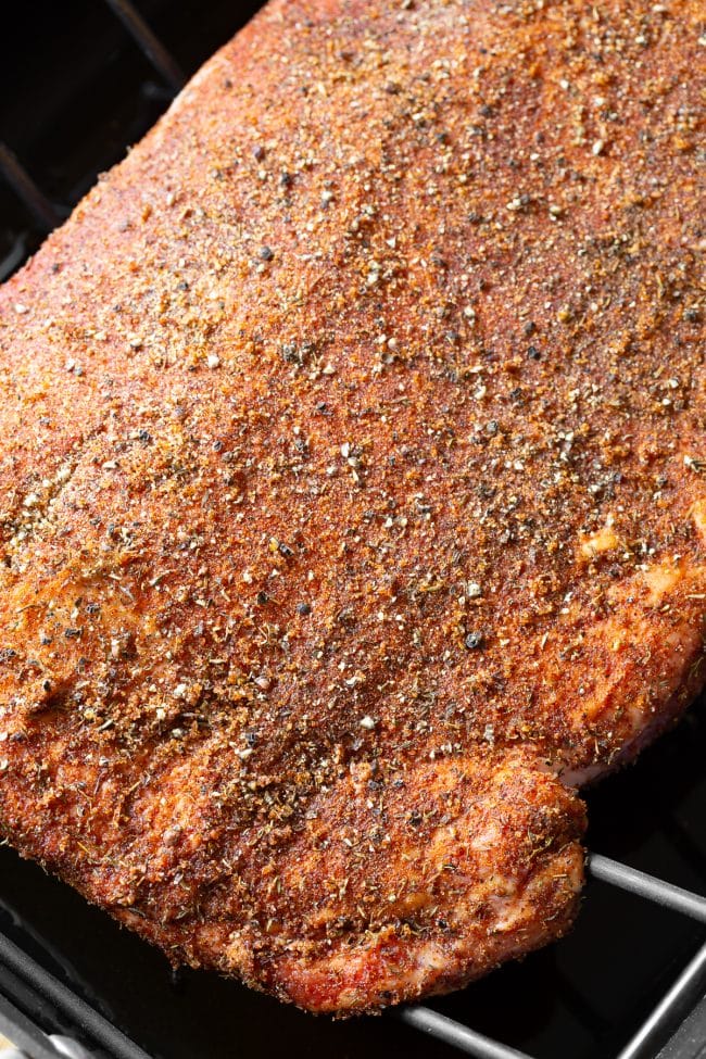 Close up shot of beef brisket with dry rub on it. 