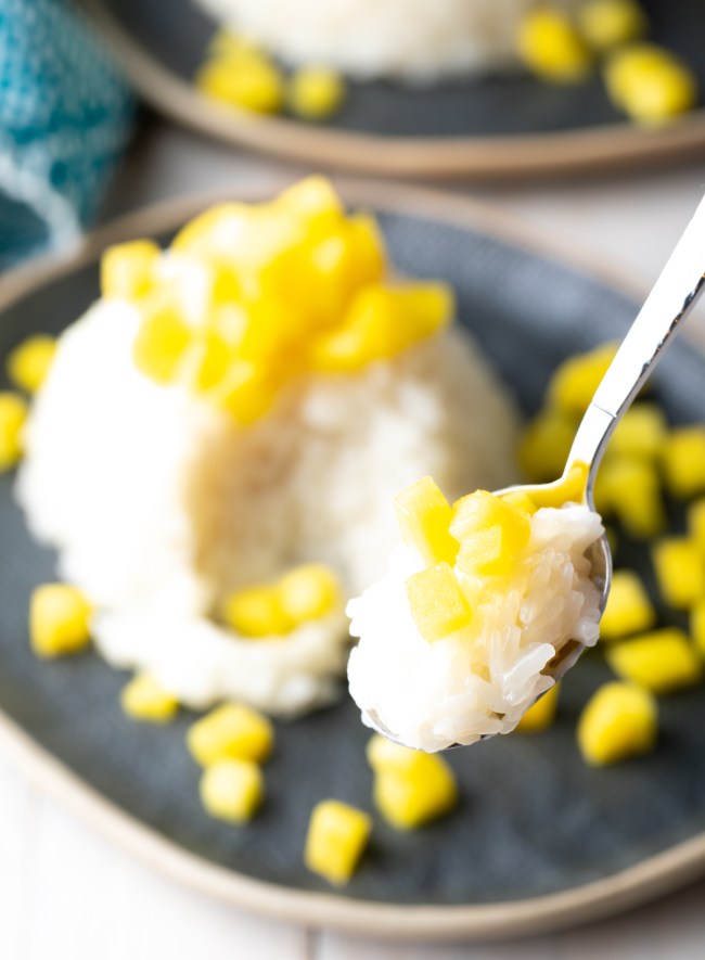 coconut sticky rice with mango on spoon