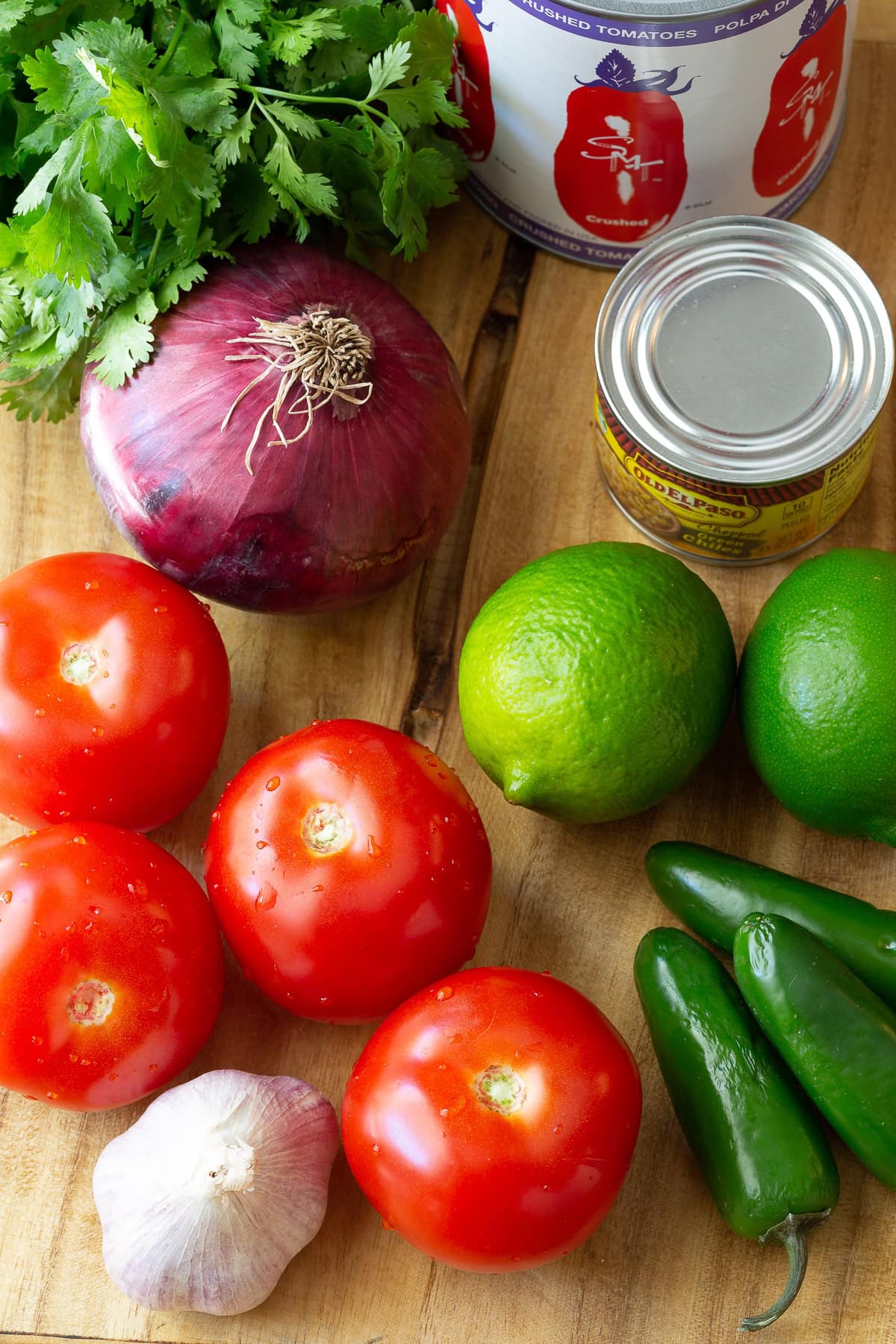 Ingredients for fresh homemade salsa on a wooden surface. 